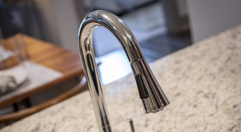 a kitchen faucet with a chrome finish at The Teak at  Branch