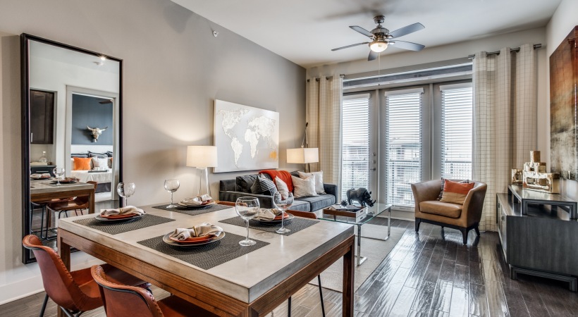 a living room and dining area with hardwood floors at The Teak at Branch