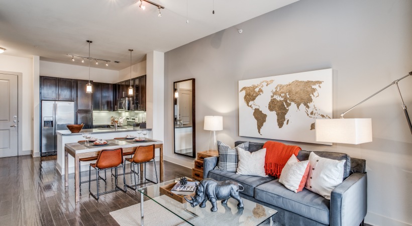 a living room and kitchen area with a large map at The Teak at  Branch