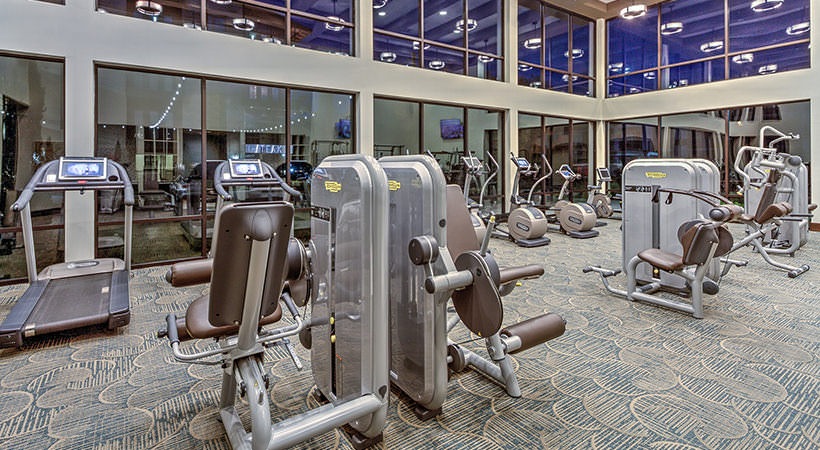 a gym with tread machines and exercise equipment at The Teak at  Branch